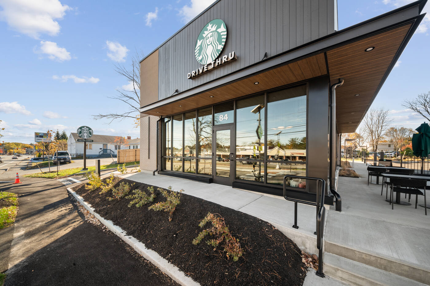 Angled entrance and roofline of a commercial retail building, corrected-perspective architectural photo