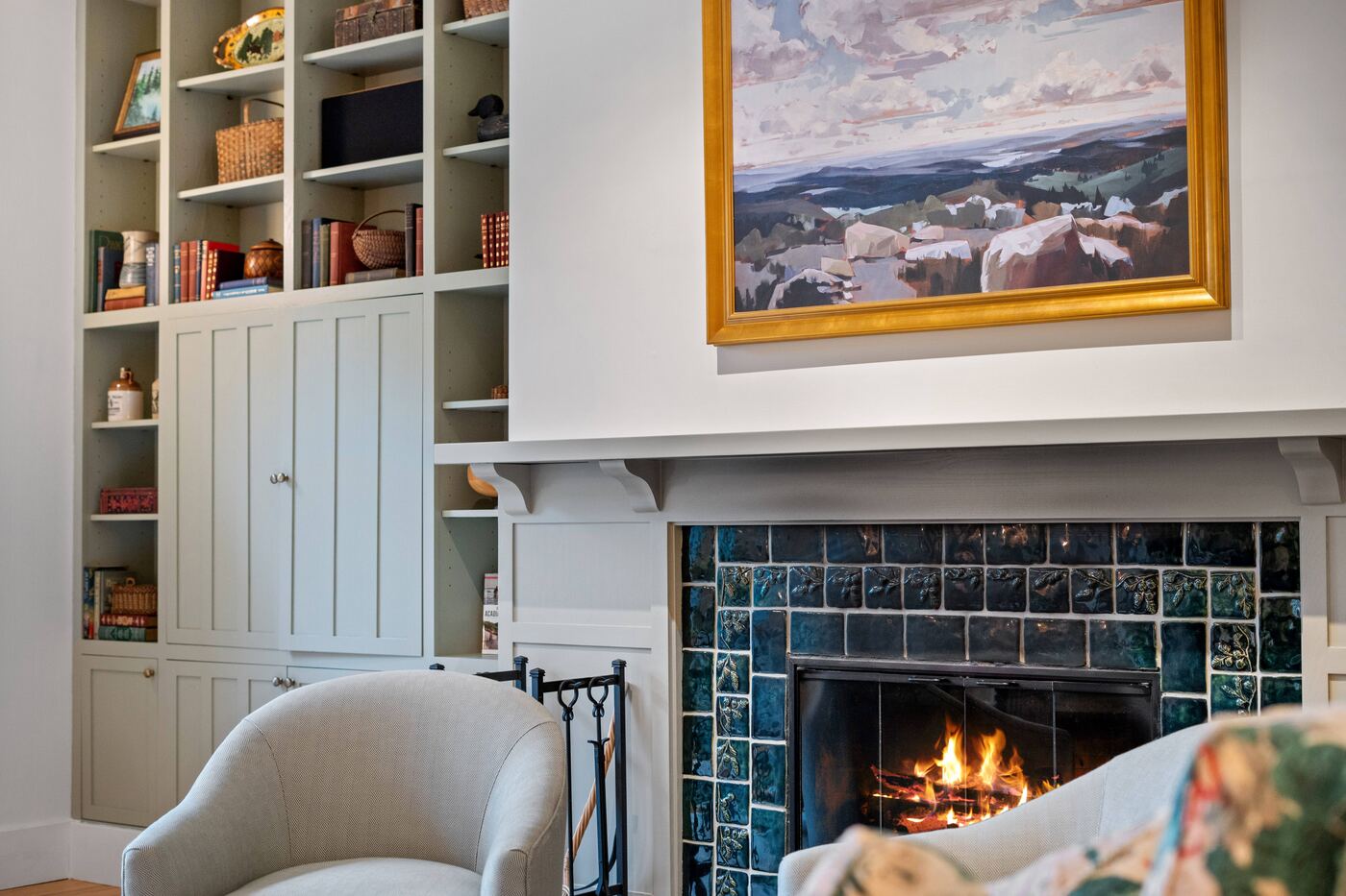 Built-in bookshelves and stone fireplace in a warm, editorial-lit living room
