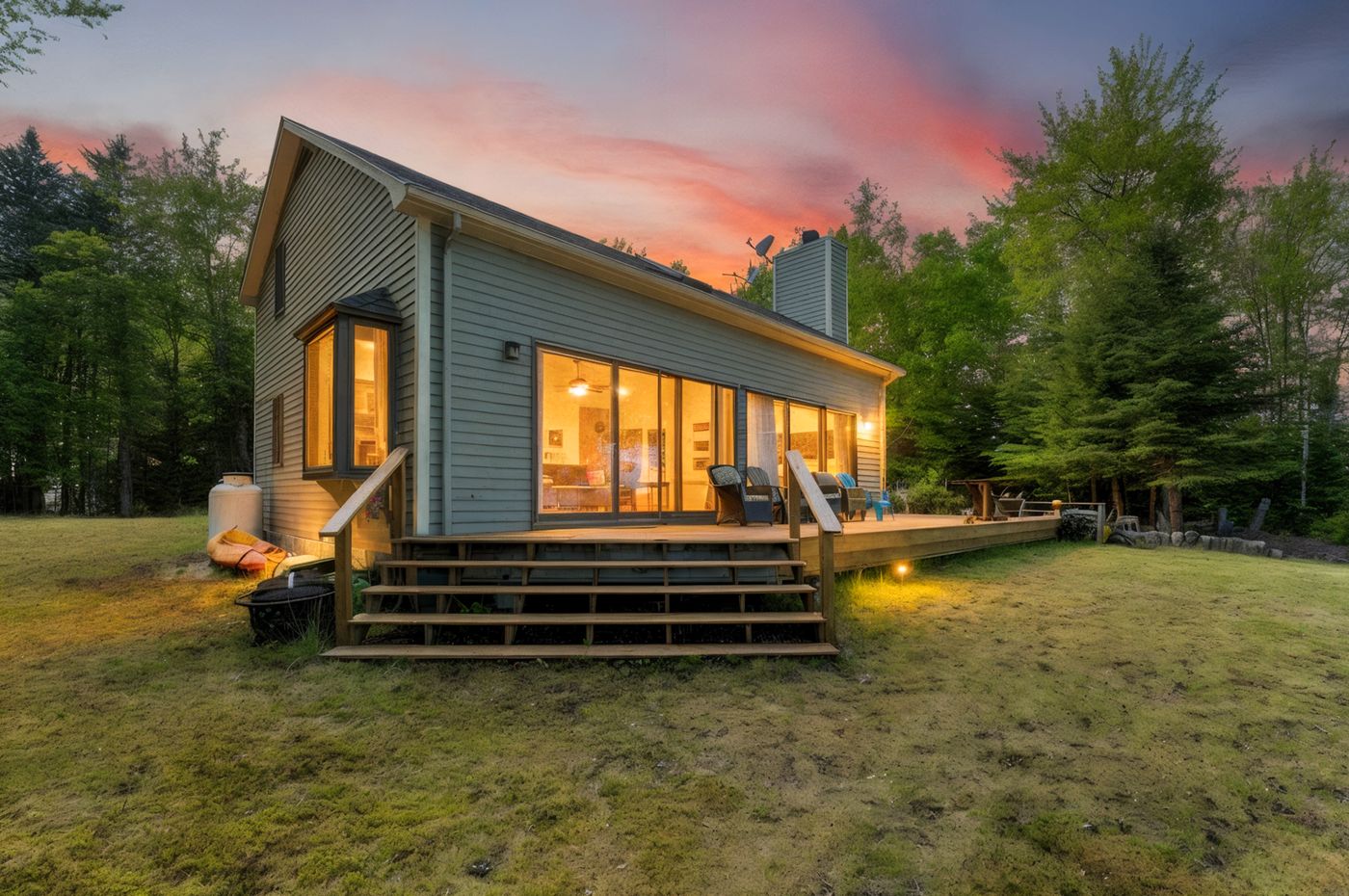 Home exterior at virtual twilight with warm lighting